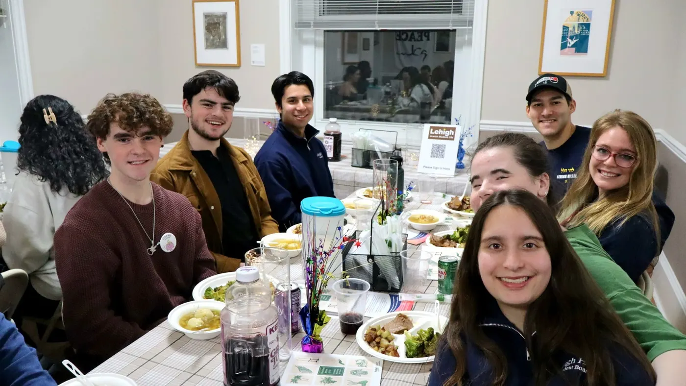 Students around the table at Shabbat dinner